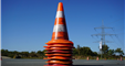 A cone sits in a roadway.
